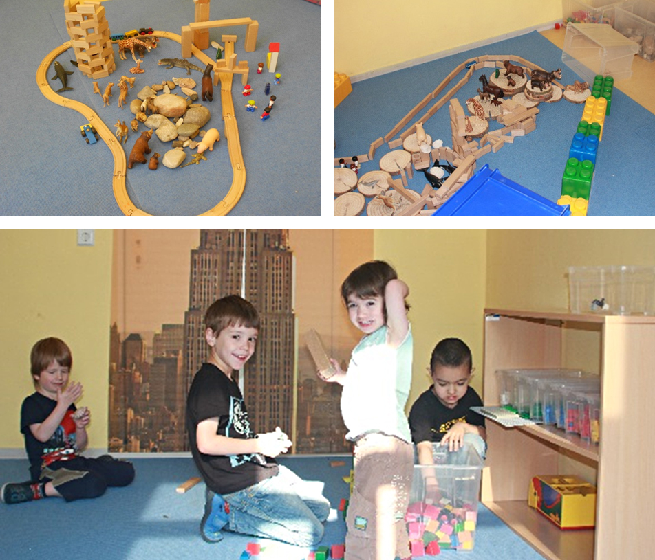 Mit Holzeisenbahnen, Bauklötzen, Tieren bauen die Kinder ihre Spielwelten.